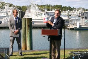 DNREC Secretary David Small holds Kirkpatrick's Oysters can, adding his hopes for the future success of the shellfish aquaculture industry in Delaware's Inland Bays, during an announcement Oct. 3 that two federal grants will provide nearly $200,000 to the program's research and marketing efforts. BY MADDY LAURIA
