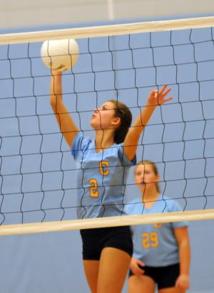 Beacon's Brooke Hollingsworth gets a spike for a kill. BY DAN COOK