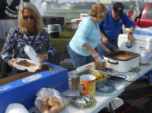 Donna Parker of Millsboro and Joe and Ginny Valentine prepare food for the veterans receiving a free lunch while waiting for their free oil change at Meineke. Joe is a Vietnam veteran who served in the Army from 1968-71. Donna, whose husband George served in the Navy from 1966-70, and Ginny are patron members of Post 2931. BY CHRIS FLOOD