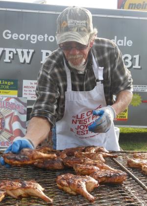 Jeff Webb of Ellendale pulls chicken breasts off the barbeque. Webb is a post volunteer. BY CHRIS FLOOD