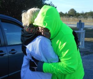 Hill hugs his wife Cindy before setting off on his walk. BY CHRIS FLOOD