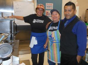 From prep work, serving and then cleaning, nearly 100 volunteers helped the church pull off the meal. Here (l-r) Cara Wilson, Linda Kauffman and Juan Escamilla take a break in the kitchen. BY CHRIS FLOOD