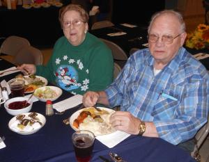 Arlan and Edna Schaller of Rehoboth Beach enjoy a plate of food. The couple said they came to the church's meal because it's just the two of them and it's nice to be around the people. BY CHRIS FLOOD