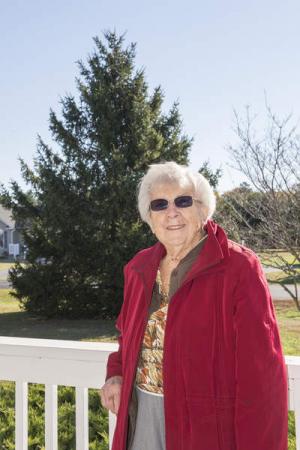 Josephine Hearne poses with the Christmas tree she donated to Rehoboth Beach in 2013. BY DENY HOWETH