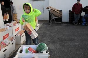 Braeden Russ helps with loading the boxes. BY STEVEN BILLUPS