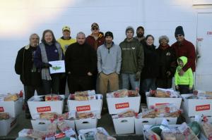 Shown gathered for a photo with their boxes of food are standing in back (l-r) George Russ, King Lion Pete Dirks and Mike Brittingham. In front are Beth Hicks, Phillip Russ, Christopher Russ, Tommy Engle, Sara Gildon, Liz Brittingham, Trevor Gildon and Braeden Russ. BY STEVEN BILLUPS