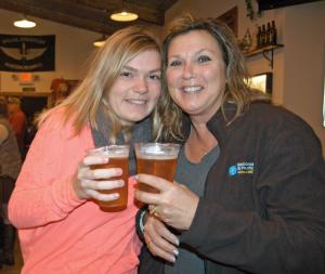 Lewes resident Ashley Vansant, left, and Diana Vansant cheer to Delaware Day during a celebration at 16 Mile Brewery in Georgetown. BY MADDY LAURIA