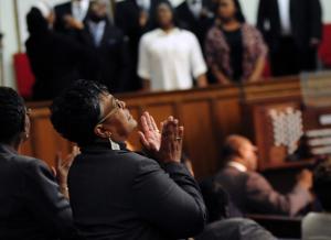 Wanda Hopkins praises God during the St. John 2nd Baptist Church choir's performance. BY DAN COOK