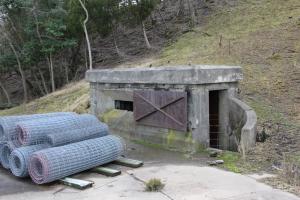 A heavily fortified entrance to the bunker - in preparation for attacks by assault forces - stands in front of one of the 12-inch diameter shell gun emplacements. BY DENNIS FORNEY