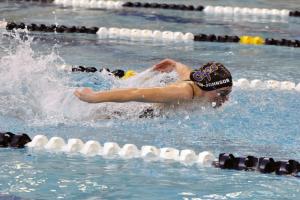 Sophomore Amelia Nigh-Johnson pulls through her lane and wins the 100 butterfly with a time of 1:09.20. BY DAN COOK