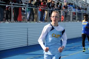 Zach Simpler finishes the 100 meters. BY DAVE FREDERICK