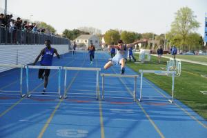 Sam Young wins the 300 hurdles. BY DAVE FREDERICK