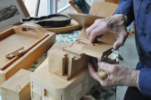 Among Warren Walls creations are several puzzles. He shows how one of those puzzles works. BY NICK ROTH