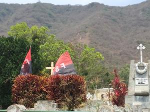 The black and red flags of the Sandanista party fly over graves in the impressive cemetery of Jinotega in the central mountains of Nicaragua.