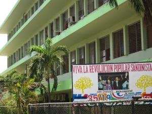 A Sandanista billboard stands in front of a relatively new building in the downtown area of Nicaragua's colonial capitol of Léon.