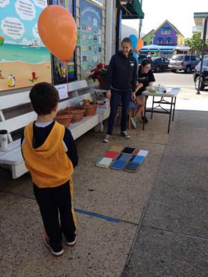 Children had fun at the celebration getting face painted and playing Book Toss. Shown leading a game of Book Toss is Nichole Zechman. BY SUBMITTED