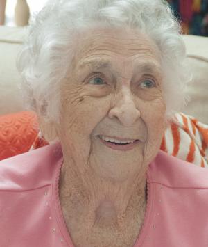 Virginia cracks a smile for her cousin. BY DENY HOWETH