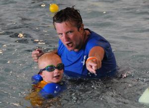 YMCA aquatics director Lydia Schmierer directs Max Wyshok during the World's Largest Swimming Lesson. BY DAN COOK