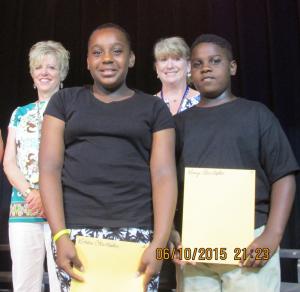 Twins Kimora and Kanye Christopher pose with their certificates while Principal Christy Greaves, back left, and teacher Chrissie Maughn look on. BY SUBMITTED