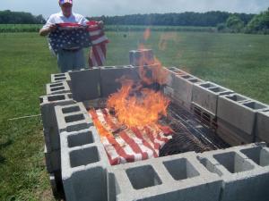 Part of the Flag Day ceremony was the respectful burning of retired flags from all over Sussex County. Flags are collected and stored through the year by various organizations which turn them over to the Elks for the flag-burning ceremony. The Flag Retirement Team includes Wayne Braddock, Ed Guditus and Paul Smallwood. Shown is Ed Guditus at the ceremonial burning. SOURCE SUBMITTED