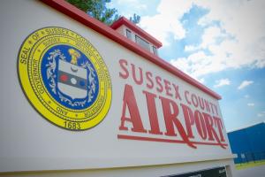 It won't be long before a new sign will go up in front of the county's airport as the name is changed to Delaware Coastal Airport. BY RON MACARTHUR