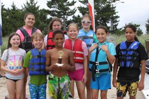 Jayvon Erisman, winner of the kids kayak event, holds his trophy alongside some of his friends and competition. BY BECKY CRAFT