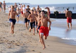 Joe Giles, 10, of the Rehoboth Beach Patrol wins the beach run competition. BY DAN COOK