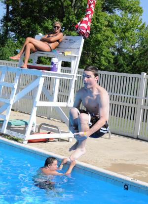 SODE athlete William Connor performs a cannonball with lifeguard Karli Smith watching. BY DAN COOK