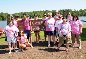 Cabin four roomies poses with the Camp Barnes sign. Shown (l-r) are Beth Fuhs, Tamika Manlove, Marissa Robinson, Lauren Conley, Shirley Owens, Laura Tomlinson, Kate Steller, Rachel Grimm, Kim Strunk, Marry Getty, Deborah McDaniel, Beth Lints, Hannah Worsh and Connie Smith. BY DAN COOK