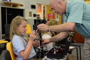 Christopher Buzby assists sixth grader Brooke Emeigh, left, of Seaford with the assembly of her new clarinet. SOURCE SUBMITTED