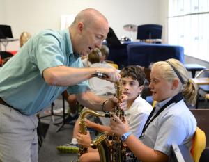 Christopher Buzby, left, works with sixth grade students, saxophonists Carter McCabe, center, of Millville and Grace Baeurle, right, of Rehoboth Beach. SOURCE SUBMITTED