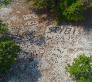 Several words, designs and messages dot the sand near the tower entrance. BY RON MACARTHUR