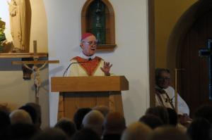 Bishop Malooly delivers the homily to the crowded church. BY STEVEN BILLUPS
