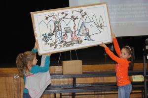 Lindsay Hamlett, left, and Erin Lynch hold up a poster showing a few things campers should not do. BY MELISSA STEELE