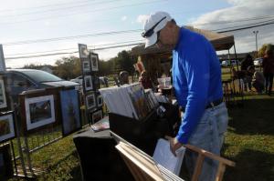 Bob Gentry from Rehoboth Beach browses the photography by Heather Orkis from Townsend. BY STEVEN BILLUPS
