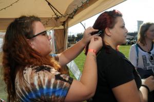 Tricia Miller of BoHo Gypsy Hair Wraps works on hair wrap designs with Nicole BeMiller from Millsboro. BY STEVEN BILLUPS