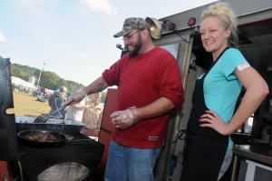There were multiple food trucks at the festival. Shown cooking for Mr. Barbecue are Kris Abbott and Jessica Pinkham. BY STEVEN BILLUPS