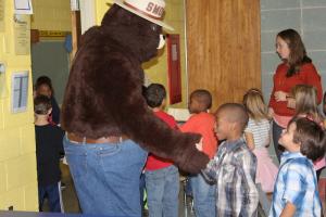 Lamar Jones shakes hands with Smokey Bear while Jacob Buda waits his turn. BY MELISSA STEELE