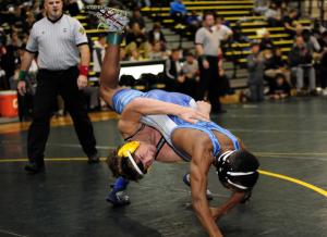 Cape's Justin Wright, back, throws down and defeats Lake Forest's Andre Flandy by a score of 12-2. BY DAN COOK