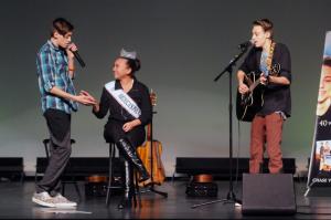 Julian, left and Adrian Woodrow of Take 2 serenade America's Pre-Teen Ava Rae Wilson from Delaware during the concert. BY STEVEN BILLUPS