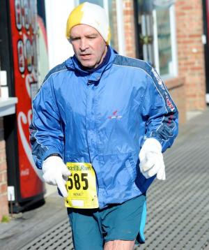 Tommy running on boardwalk in Bethany. BY DAVE FREDERICK