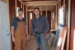 Patrick Staggs, left, stands with Lance Manlove inside the container they are transforming into a home. Staggs is president of the board and Lance Manlove is executive director of Homes of Hope. BY RON MACARTHUR