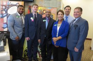 Executives from WSFS Bank, including (l-r) Clay Snead, Matt Sellers, Syed Ahmed, Laura Phillips, Greg Makowsky and Scott Swingle gather at the art show their company hosted in Millsboro. BY MOLLY MACMILLAN