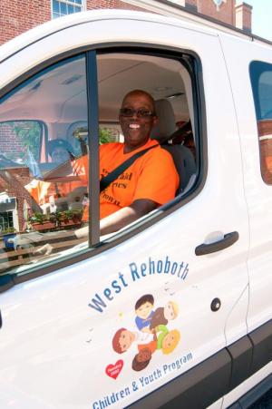 Diaz Bonevile drives the van in the parade with children from the West Rehoboth Youth Program.