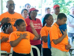West Rehoboth Children and Youth program join the audience with respect as the national anthem is sung.