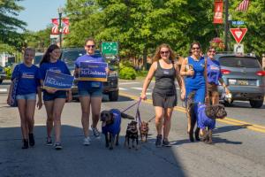 Kathy McGuiness, candidate for lieutenant governor, and her crew parade to the Richard Allen School.  Shown are (l-r) Jordan Campbell, Saylar McGuiness, Stormy McGuiness, the canine crew Lily, Sophie, Coco Chanel, and Liz V, Kathy, and Beth Thomas with Roxy.