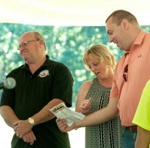 Georgetown Mayor William West, Lisa Hudson Briggs, and Sen. Brian Pettyjohn, R-Georgetown, join the group in song.