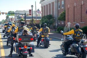 Buffalo Soldiers Motorcycle Club heads through town to the Richard Allen School.