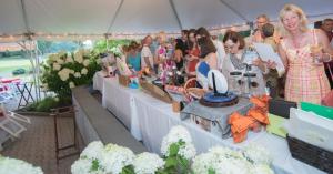 A crowd gathers at the silent auction tables.