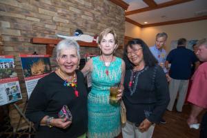 Joanne DeFiore, (l-r) Carolyn McNeice and Alice Jones check out the live auction items.